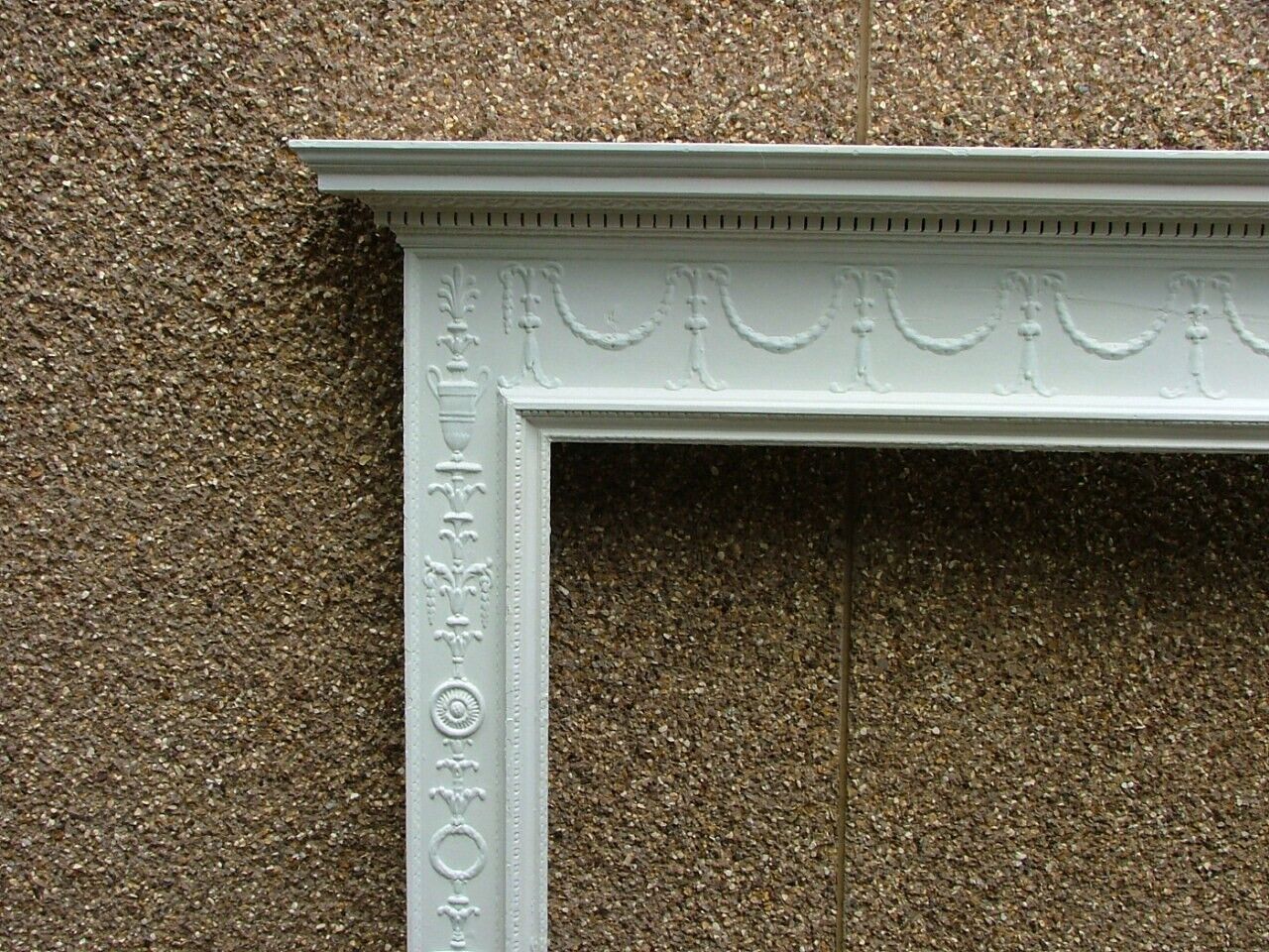 Neo-classical style painted pine and gesso chimneypiece.