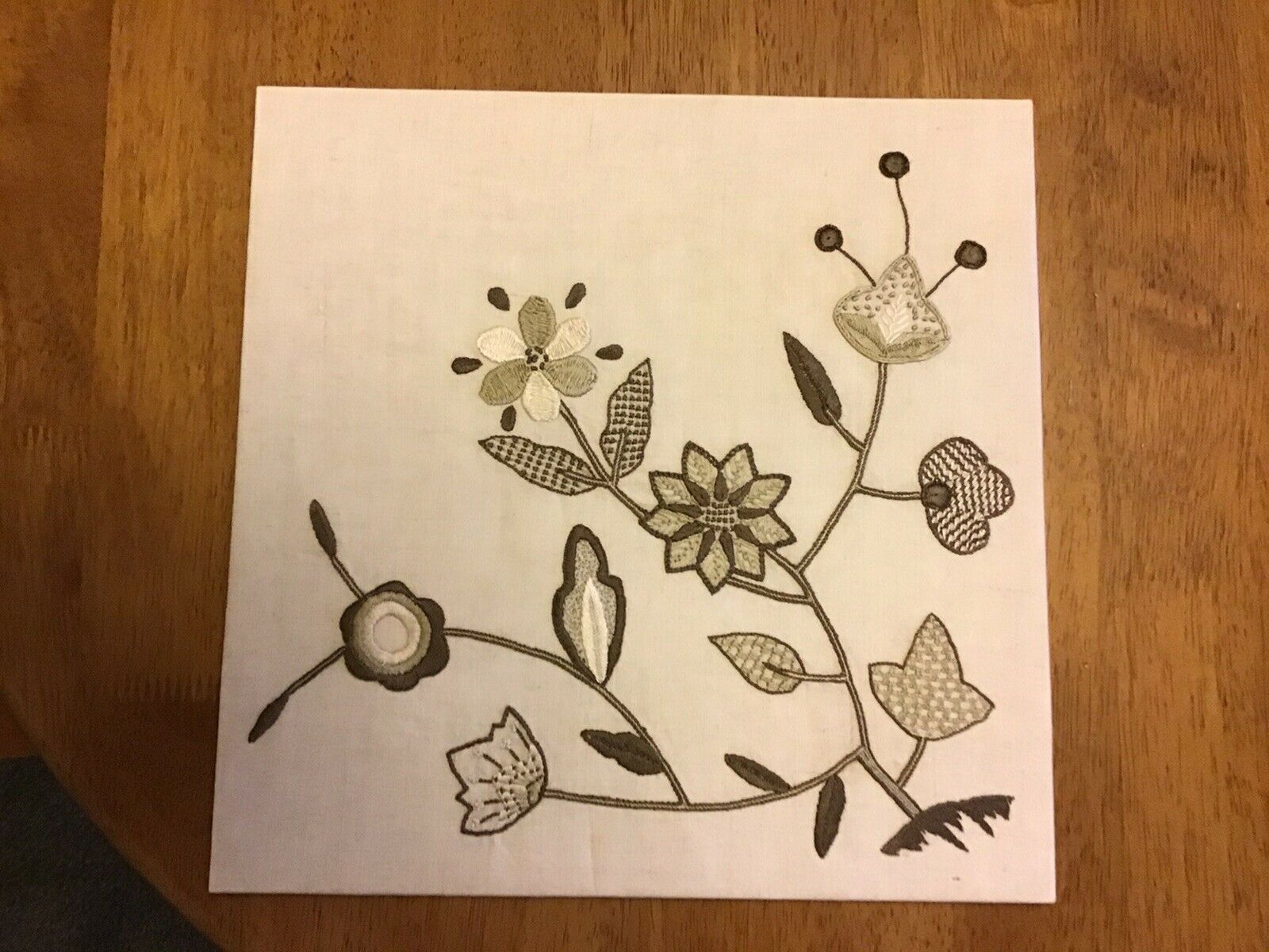 hand made flower tapestry on board
