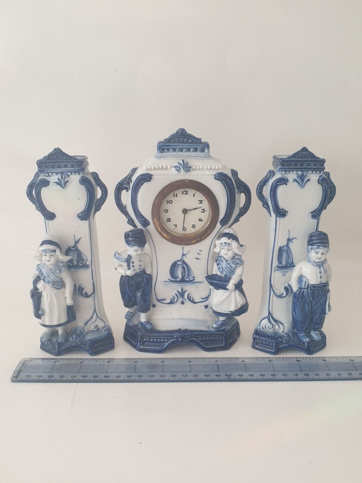 Antique Valuations: Antique Delft Blue And White Mantle Clock & Pair Of Vases Boy & Girl Decorated
