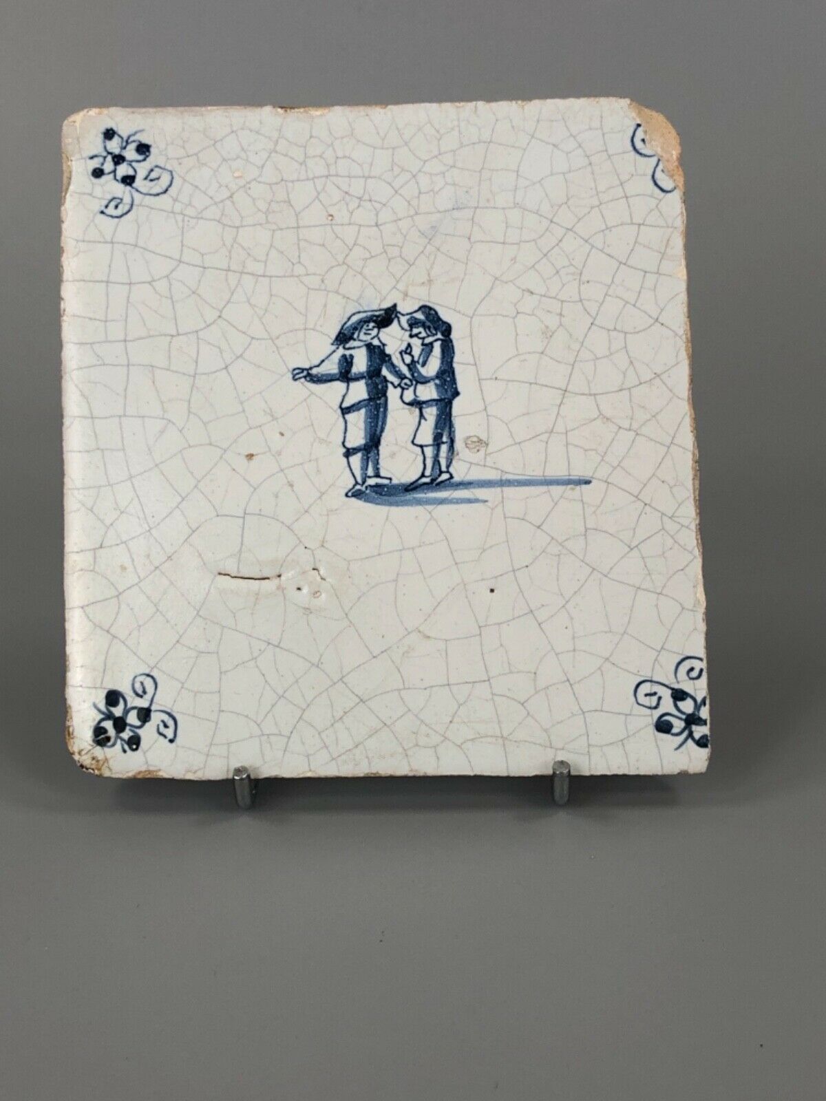 Antique Valuations: c.1675. Delft tile. Painted Scene of two men in animated conversation.